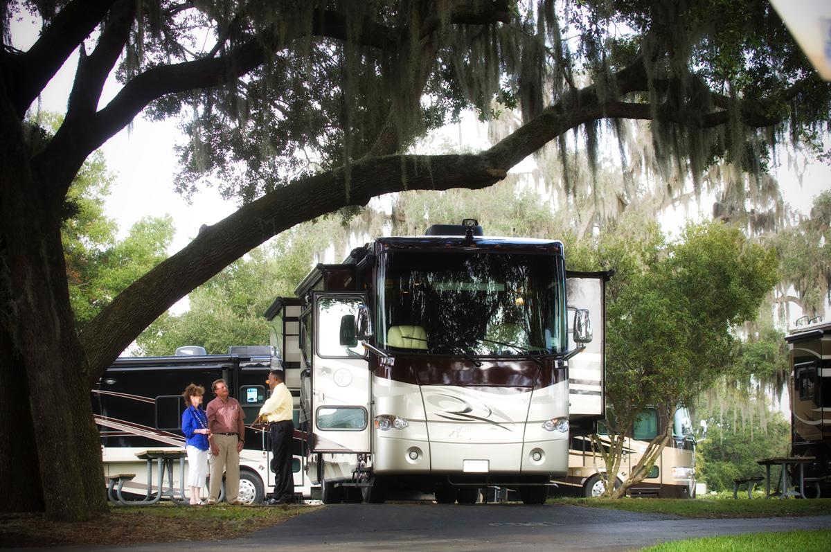 couple touring rv dealership lot